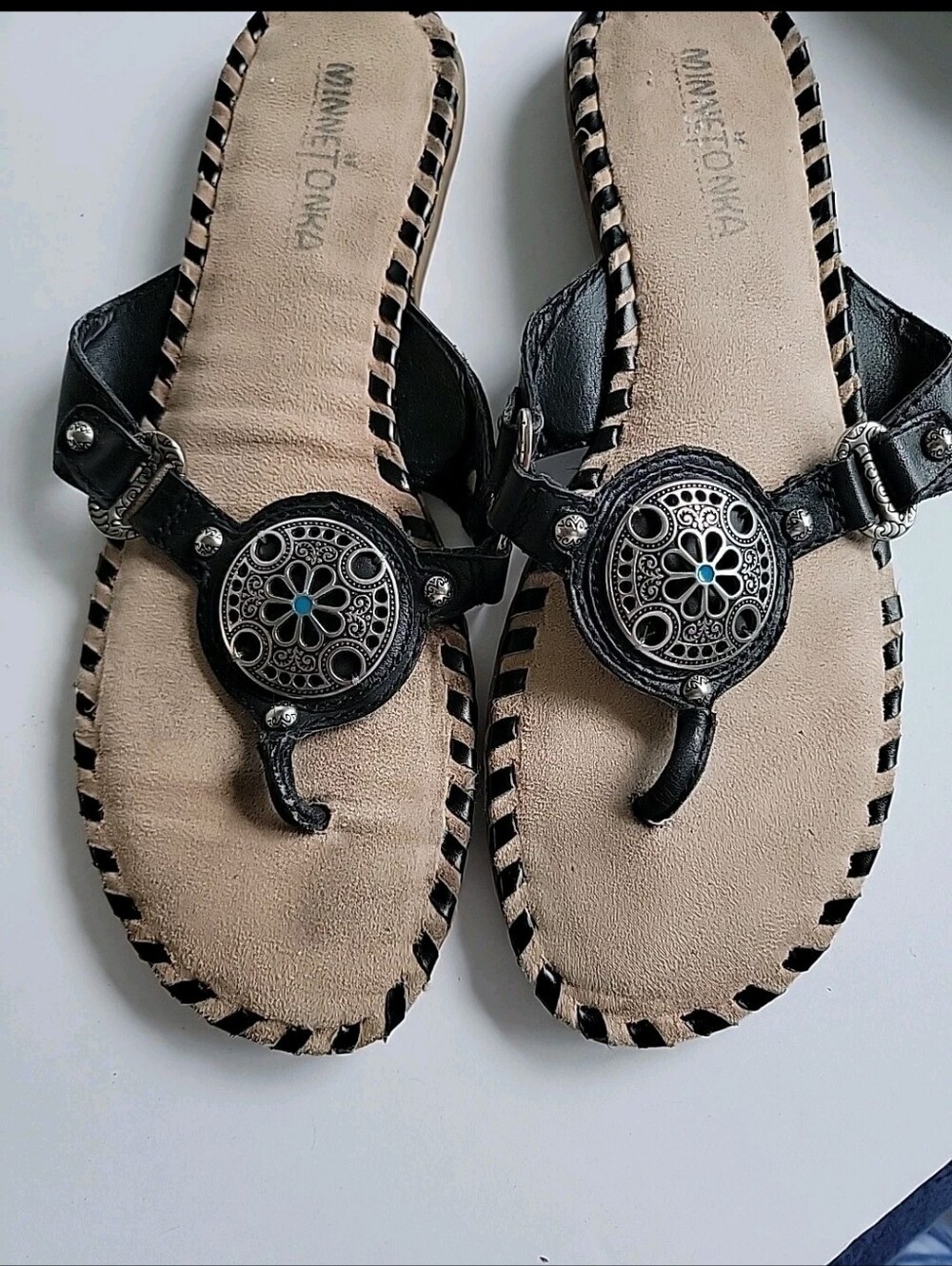 Minnetonka Black Leather Toe-Post Sandals with Silver Medallions